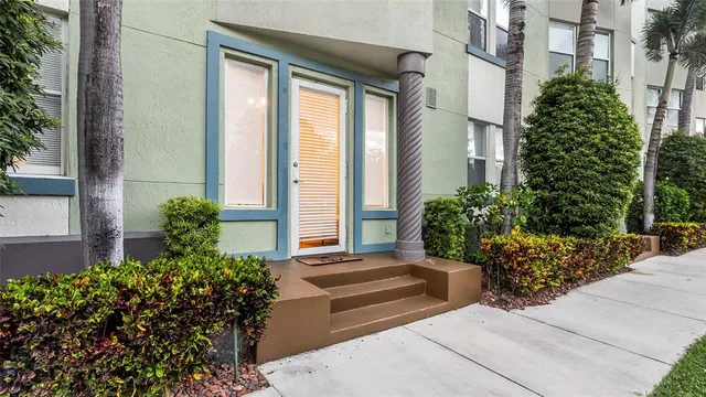 a view of a house with potted plants