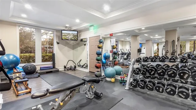 a room with gym equipment and a large window