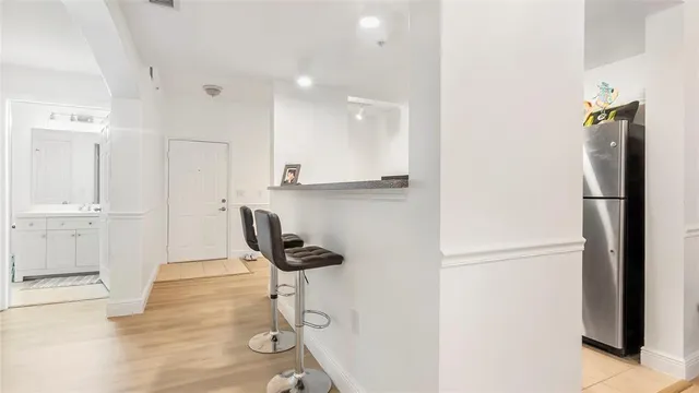 a kitchen with a refrigerator and cabinets