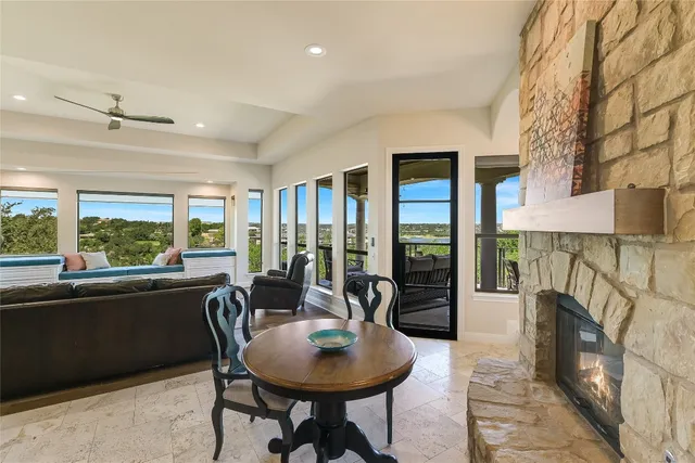 a dining room with furniture a rug and a floor to ceiling window