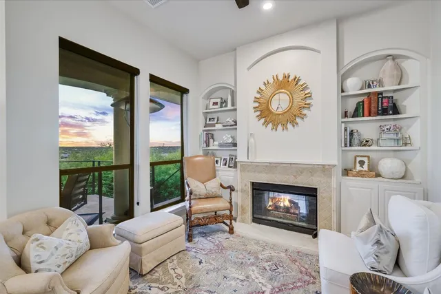 a living room with furniture a window and a fireplace
