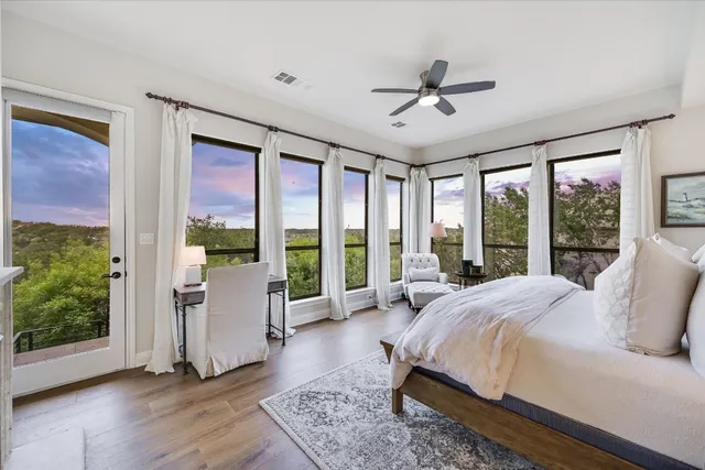 a spacious bedroom with a large bed and a large window