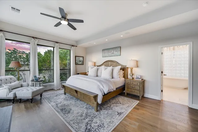 a bedroom with a large bed and a large window