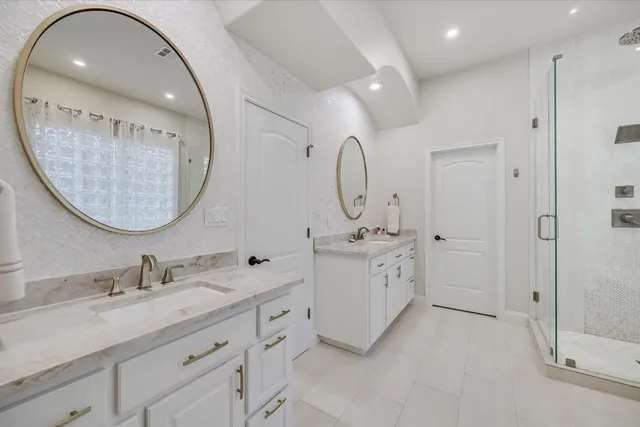 a bathroom with a double vanity sink mirror and double