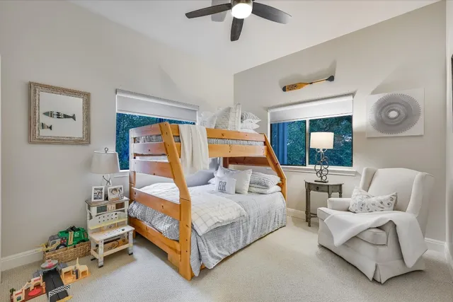 a bedroom with a bed a couch and a chandelier