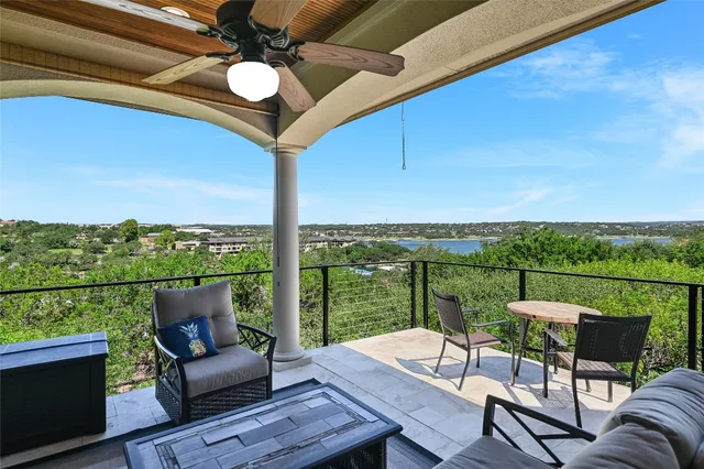 a view of a balcony with couches and pool table
