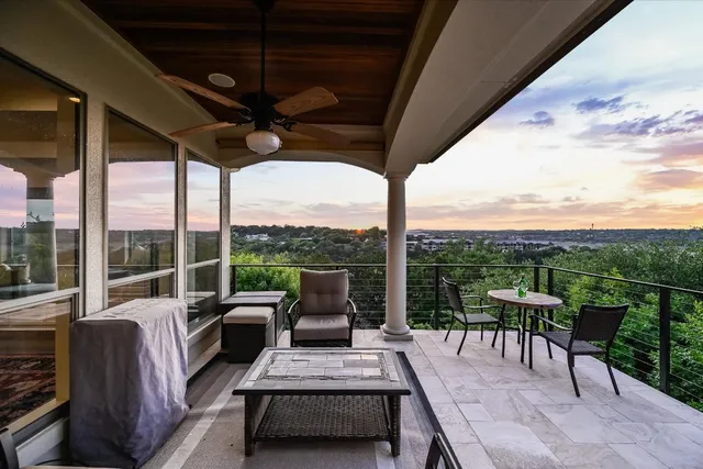 a view of a porch with furniture and a backyard