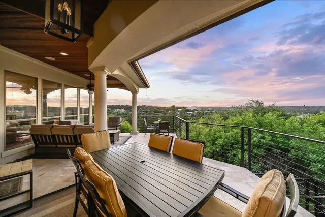 a view of a roof deck with couches and city view
