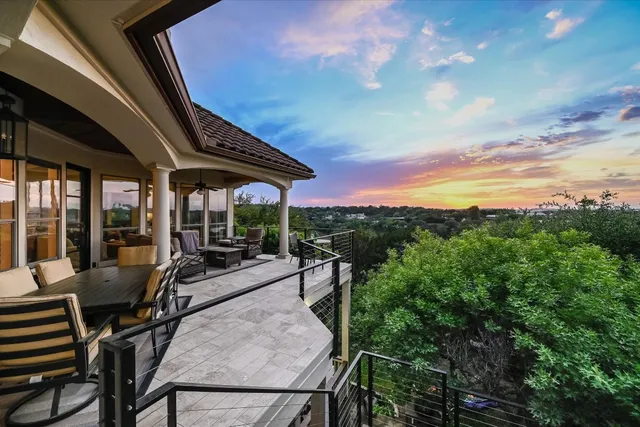 a view of a patio with table and chairs and potted plants