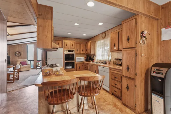 a kitchen with stainless steel appliances kitchen island granite countertop a refrigerator and a stove top oven