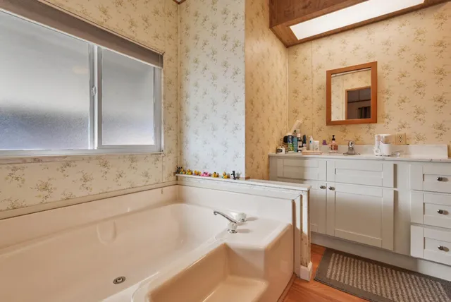 a bathroom with a toilet sink and mirror