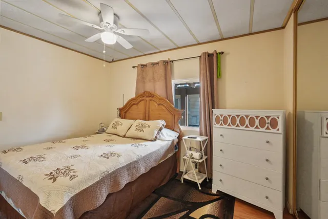 a bedroom with a large bed and a chandelier