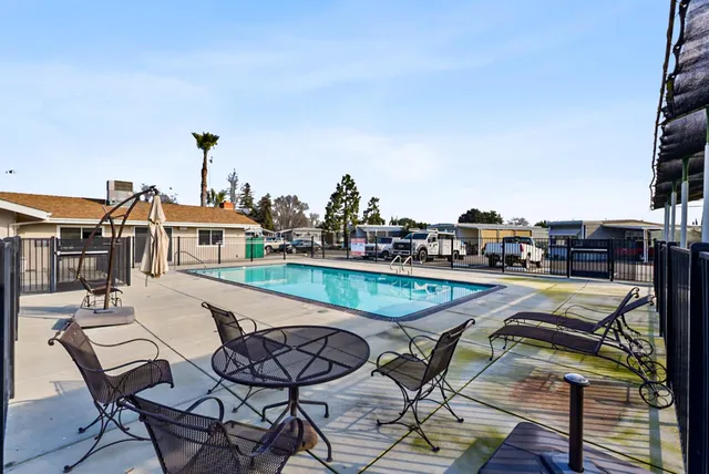 a view of a backyard with a table and chairs