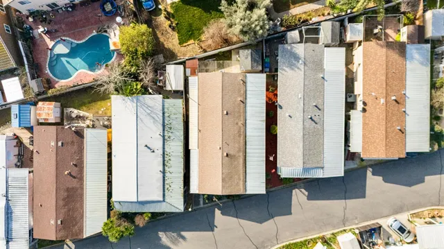 an aerial view of residential houses with outdoor space
