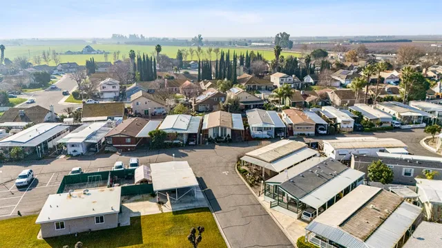 an aerial view of residential houses with yard