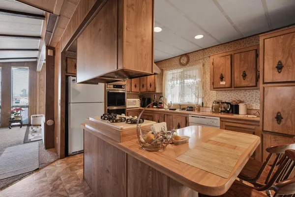 a kitchen with a stove a sink and cabinets