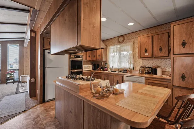 a kitchen with a stove a sink and cabinets