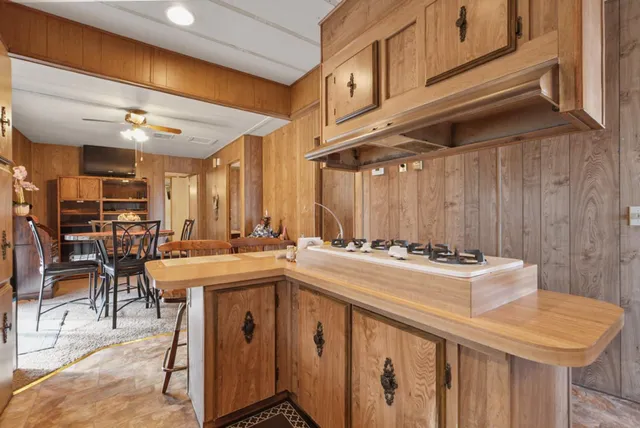 a kitchen with a stove a refrigerator and a dining table
