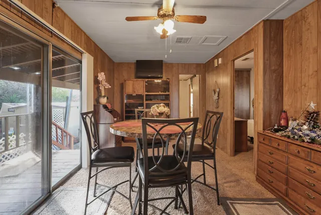a view of a dining room with furniture and a chandelier