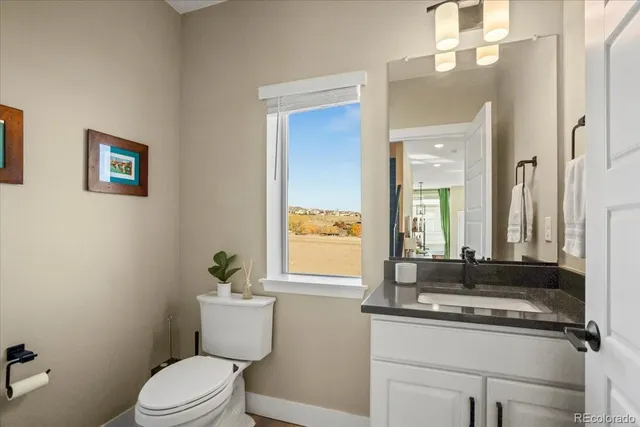 a bathroom with a sink a toilet and mirror