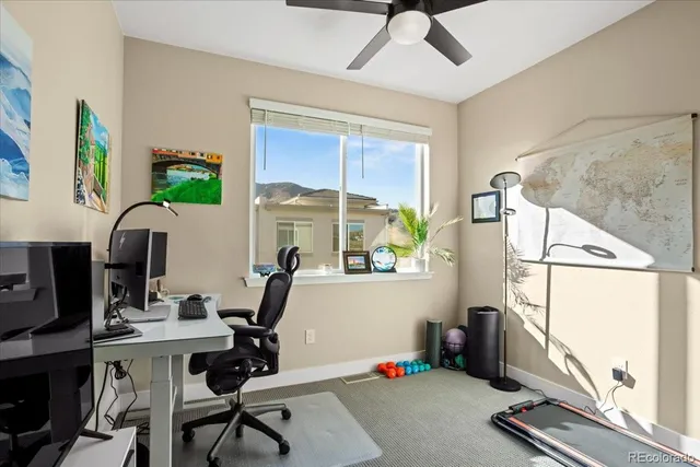 a view of a workspace with furniture and a window
