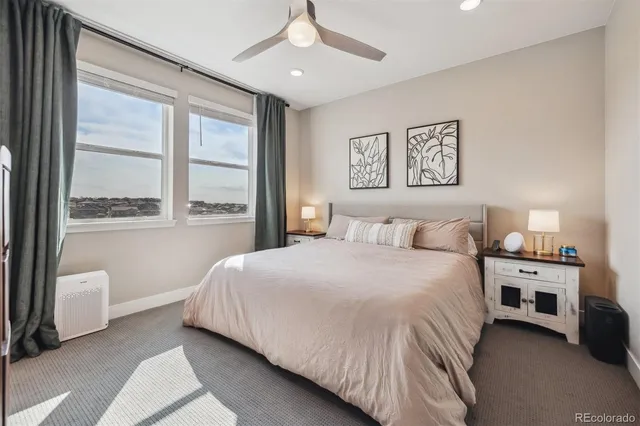 a bedroom with a bed and a large window