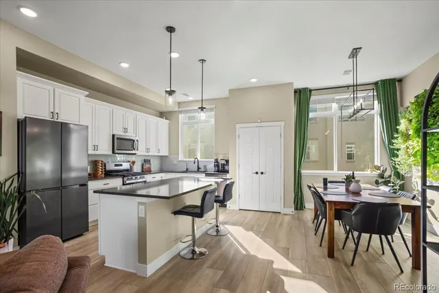 a kitchen with kitchen island a sink stove and refrigerator