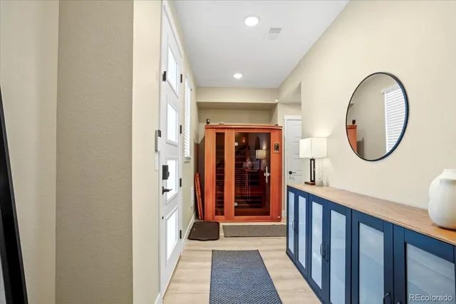 a view of a hallway with entryway wooden floor and front door