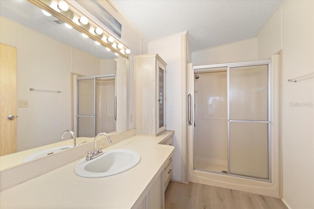 8308 Princess Court Palmetto, FL 34221 - Photo 14 of 23 a bathroom with a sink double vanity and a mirror