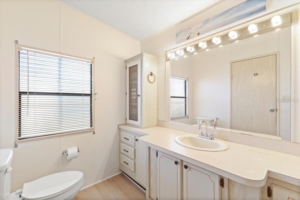 8308 Princess Court Palmetto, FL 34221 - Photo 15 of 23 a bathroom with a granite countertop sink toilet and mirror