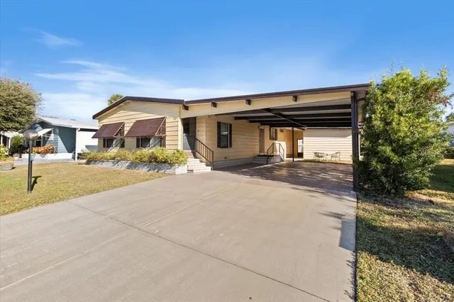 a front view of a house with large trees