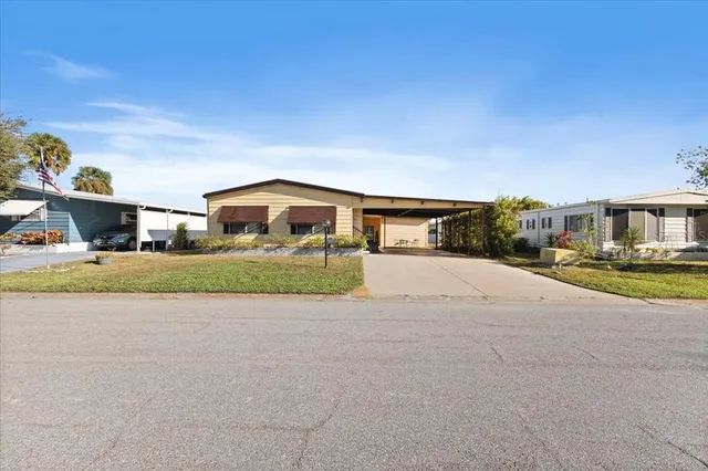 a front view of house with yard and car parked