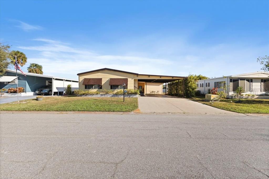 8308 Princess Court Palmetto, FL 34221 - Photo 3 of 23 a front view of house with yard and car parked