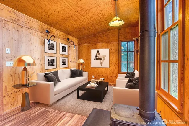 a living room filled with furniture and floor to ceiling windows