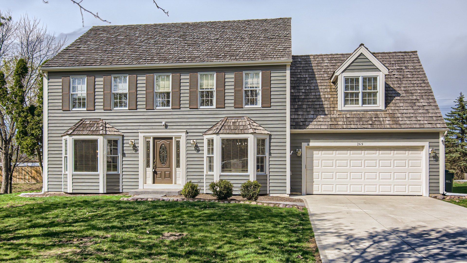 a front view of a house with a yard