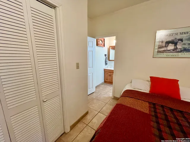 a bedroom with a bed and a potted plant