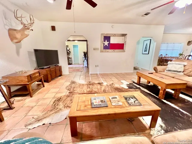 a living room with a rug and a flat screen tv