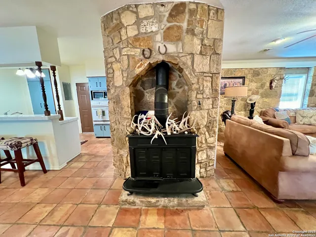 a living room with furniture a fireplace and a rug