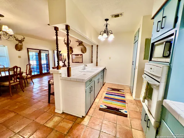 a hallway view with couches a dining table and chairs