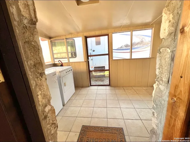 a room with window and a washer dryer