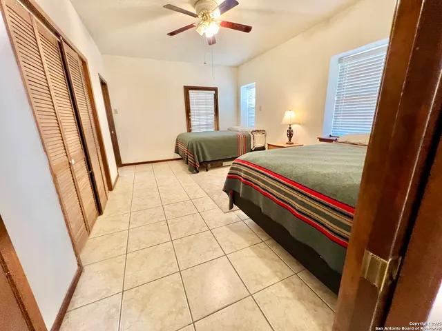 a bedroom with three beds and a window