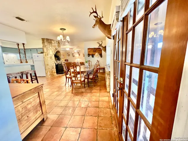 a view of a dining room with furniture and chandelier
