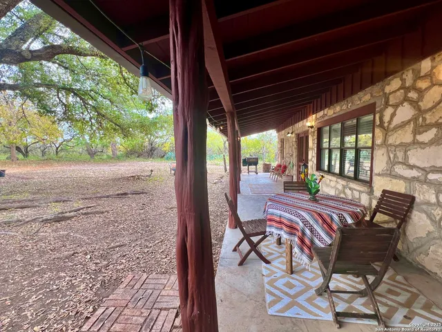 a view of a patio with a table chairs and a backyard