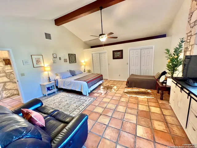 a bedroom with a bed window and couch