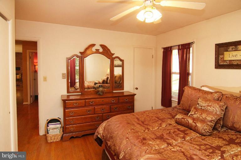 245 Stem Road Union Bridge, MD 21791 - Photo 18 of 26 a bedroom with a bed and a chandelier