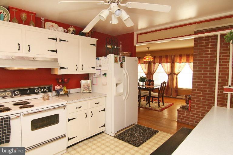 245 Stem Road Union Bridge, MD 21791 - Photo 5 of 26 a kitchen with stainless steel appliances a stove a refrigerator and cabinets