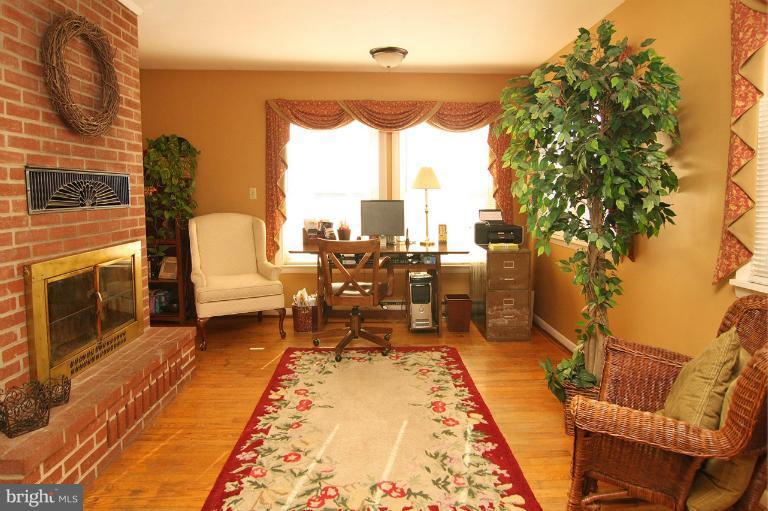 245 Stem Road Union Bridge, MD 21791 - Photo 10 of 26 a view of a patio with table and chairs potted plants with wooden floor
