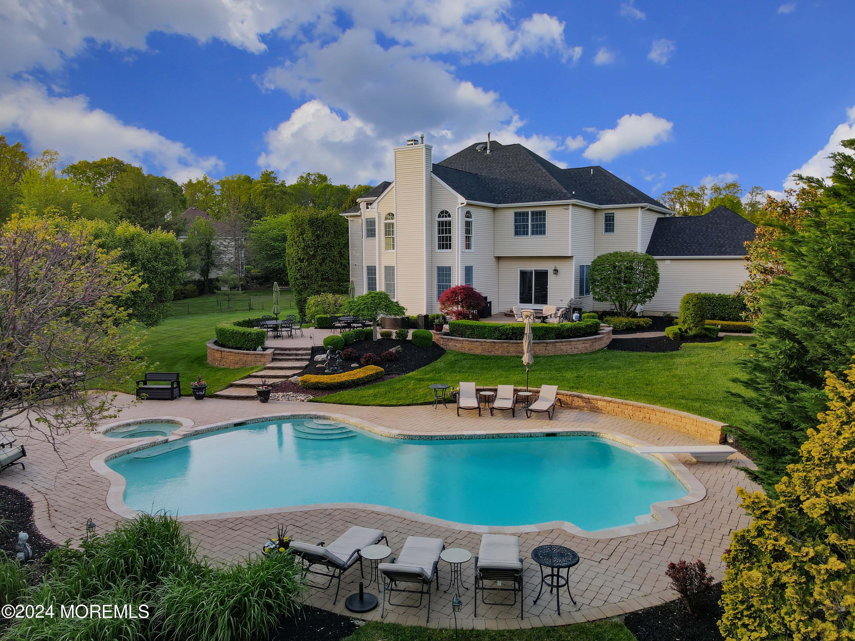 a view of a house with swimming pool and sitting area