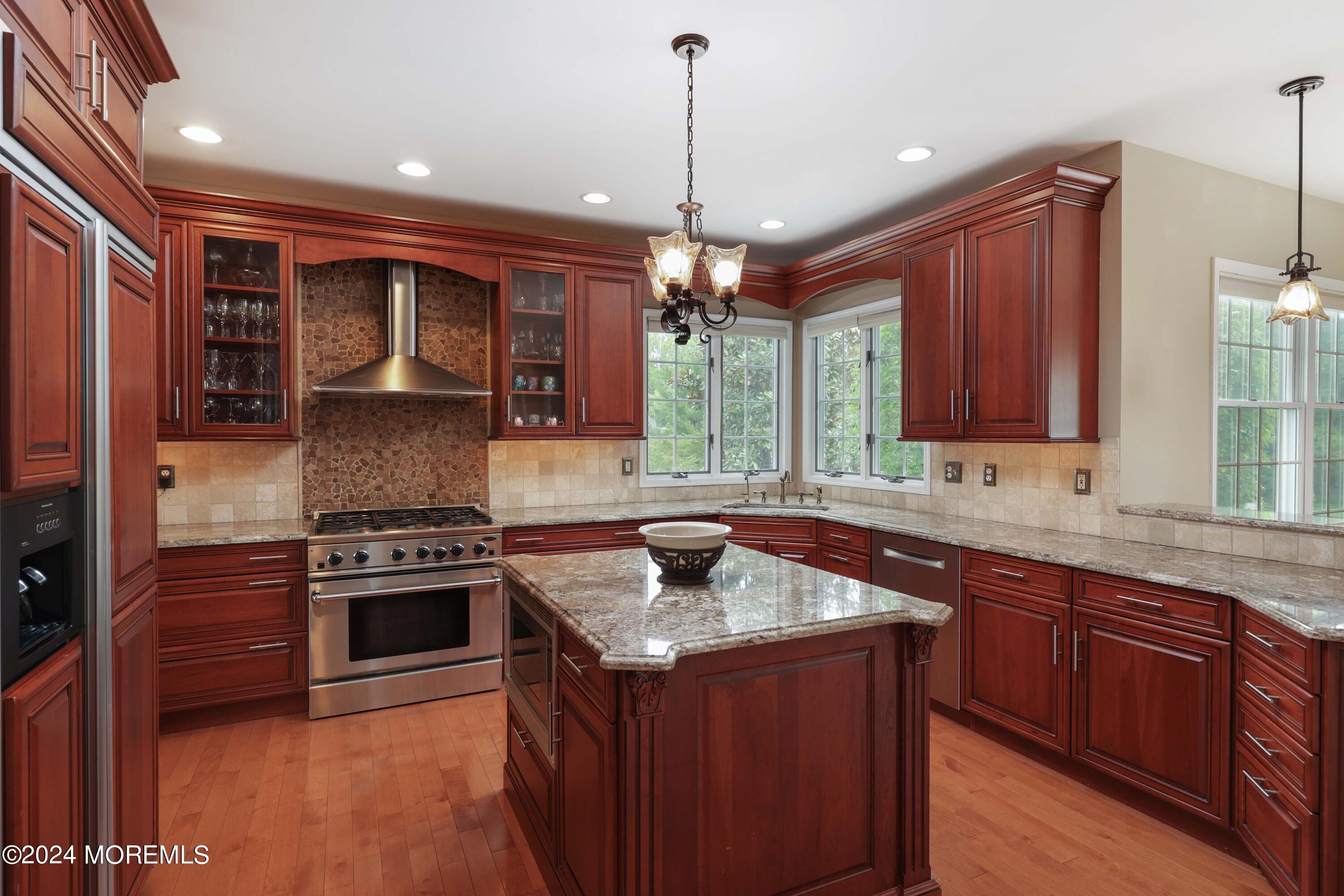 12 Shadowbrook Drive Colts Neck, NJ 07722 - Photo 11 of 33 a kitchen that has a sink stove and cabinets