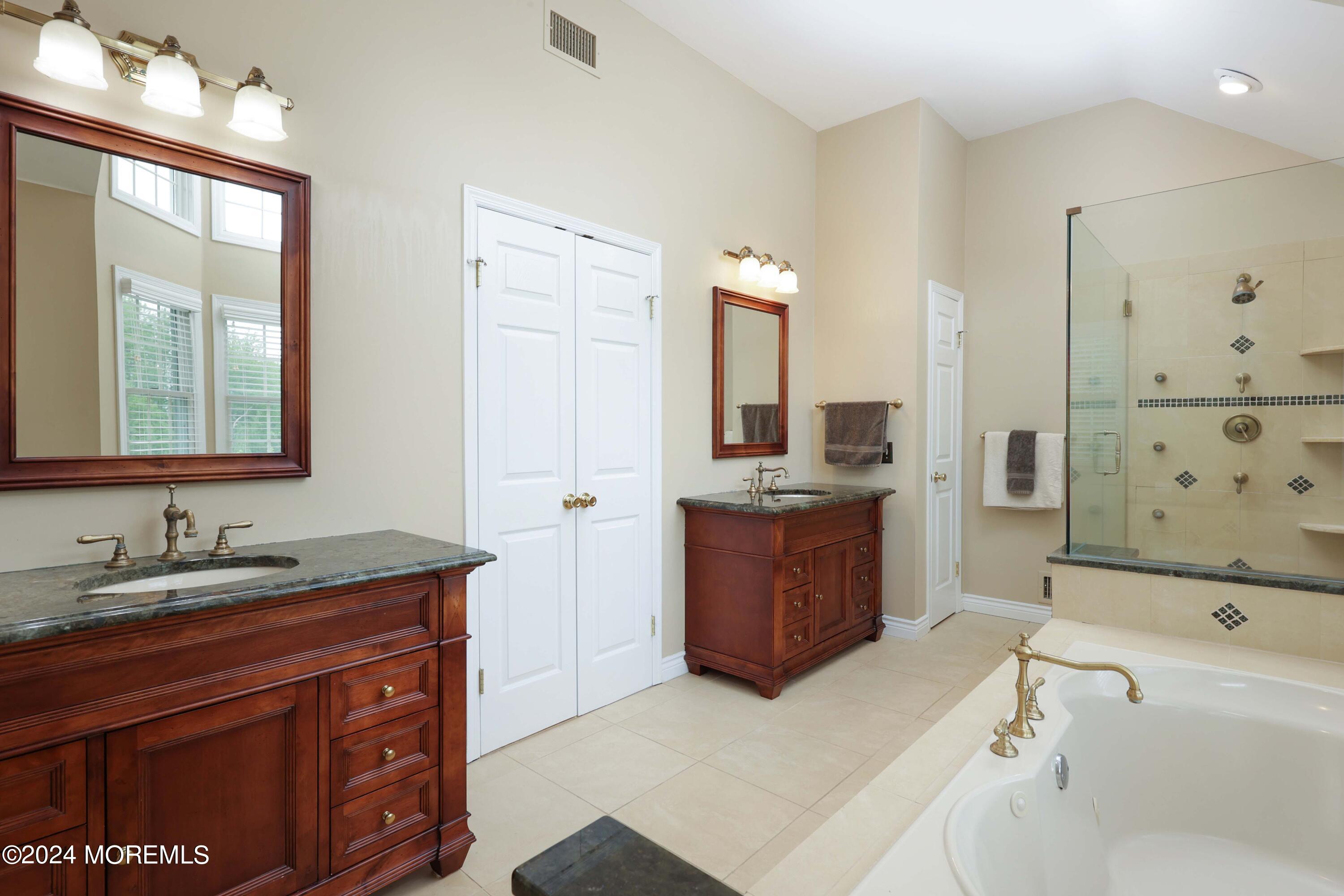 12 Shadowbrook Drive Colts Neck, NJ 07722 - Photo 18 of 33 a spacious bathroom with a tub sink and mirror